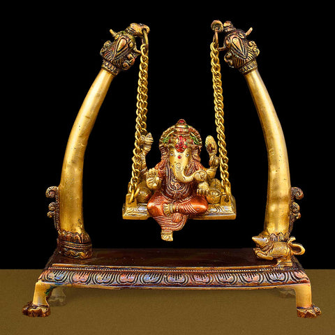 10.2-inch brass Ganpati idol seated on a decorative swing (jhula), beautifully crafted for devotion, home decor, and festive celebrations. Indiaβs Largest Brass Idols Brand - www.satvikstore.in