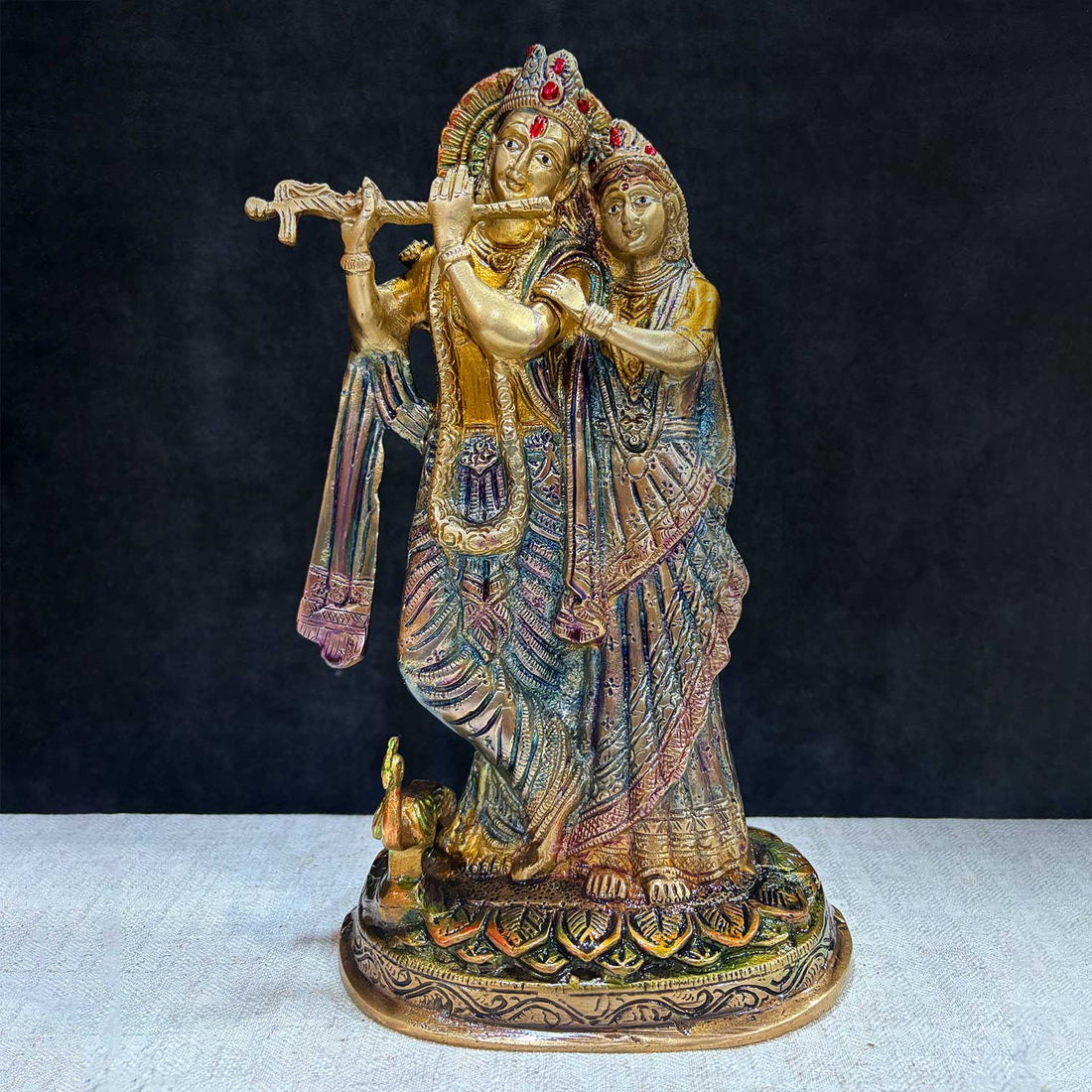 The 11.4-inch Radha Krishna โ-Divine Harmony in a Sacred Sculpture is a breathtaking masterpiece that captures the eternal and divine bond between Radha and Krishna. This beautifully detailed idol showcases the couple in a serene and harmonious pose, with Krishna playing his mesmerizing flute and Radha standing gracefully by his side. India's Largest Puja Accessories Brand - Satvik No. 1 Brass Idol Collection