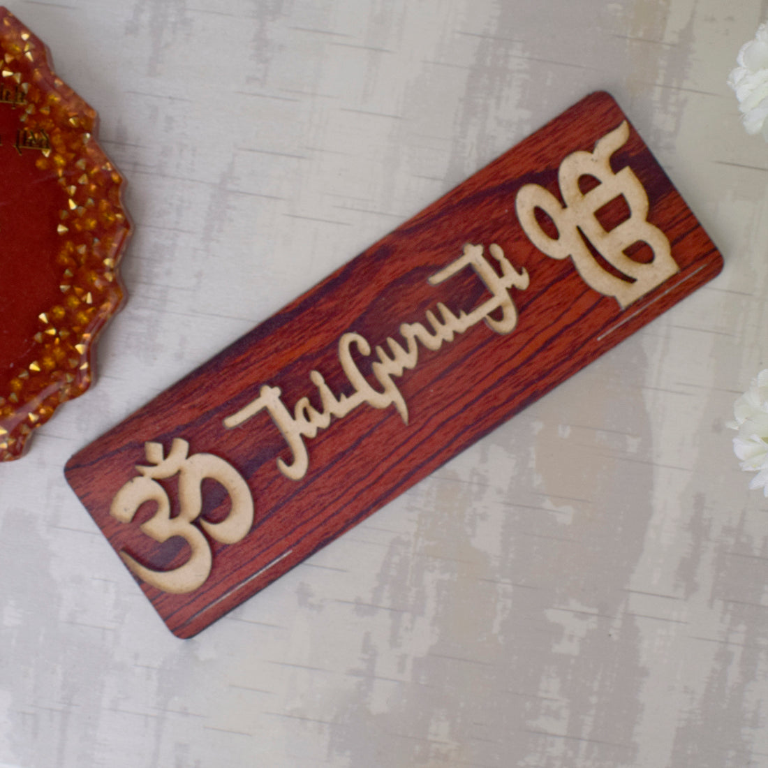 Om Jai Guruji Written on Brown MDF Sheet Door Plate