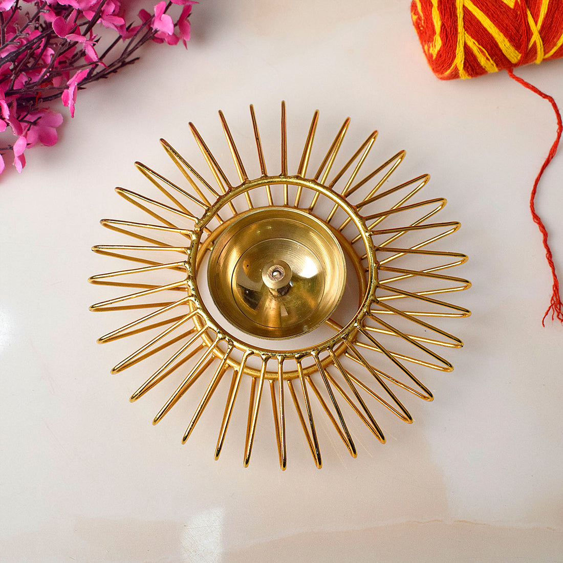 Gold-toned decorative Akhand Sun Shape Brass Diya featuring a radiant Surya (sun) motif and eternal flame chamber, ideal for spiritual lighting and festive décor. India’s Largest Pooja Accessories Brand – www.satvikstore.in