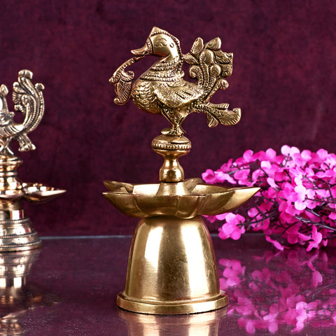 A beautifully designed Peacock Brass Diya featuring intricate detailing of peacock feathers and a polished brass finish.  Indiaβs Largest Pooja Accessories Brand β www.satvikstore.in