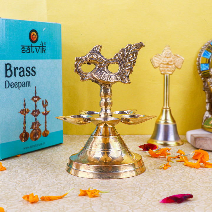 Brass 1 Step Panchmukhi Peacock Kerala Diya β Handcrafted brass diya with a Panchmukhi (five-faced) design and peacock motif, perfect for pooja ceremonies, temple lighting, and traditional dΓ©cor. Indiaβs Largest Pooja Accessories Brand β www.satvikstore.in
