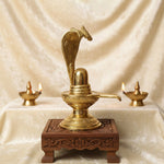 14.2-inch Brass Shivling with Nag Hood, intricately designed for divine worship and ideal for Shivratri rituals and spiritual décor. No.1 Brass Idol Store www.satvikstore.in 