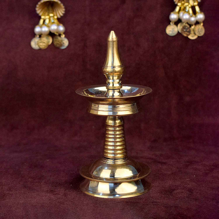 5 inch small brass Kerala diya (AKP Nilavilakku Deepam) traditional South Indian oil lamp for pooja, home temple, and festive decor. 
India’s Largest Pooja Accessories Brand – www.satvikstore.in

