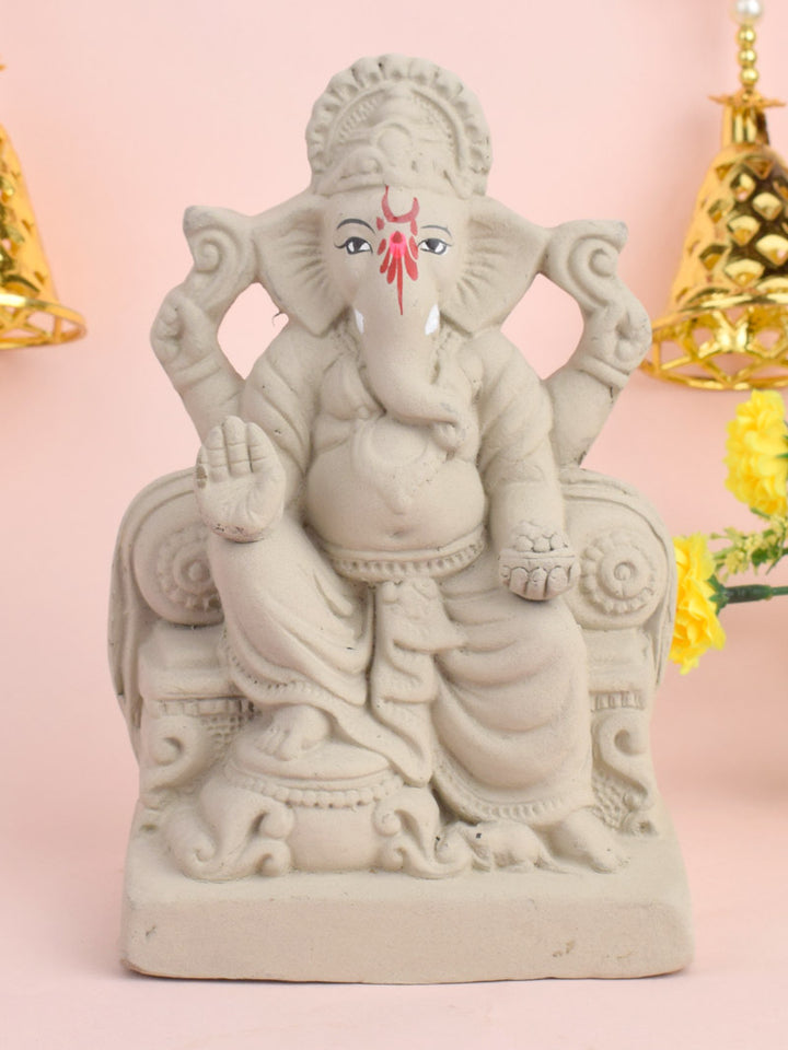 7 Inch Lord Ganesha idol seated majestically on a decorative Shinghasan, crafted in eco-friendly material with intricate detailing. India’s Largest Pooja Accessories Brand – www.satvikstore.in