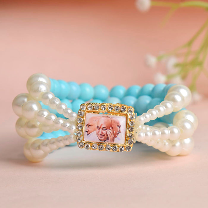 Baby Blue & White Pearl Four Layer Guruji Swaroop Bracelet featuring soft baby blue beads and luminous white pearls with Jai Guruji Swaroop – perfect for spiritual wear, festive gifting, and daily devotion. India’s Largest Pooja Accessories Brand – www.satvikstore.in