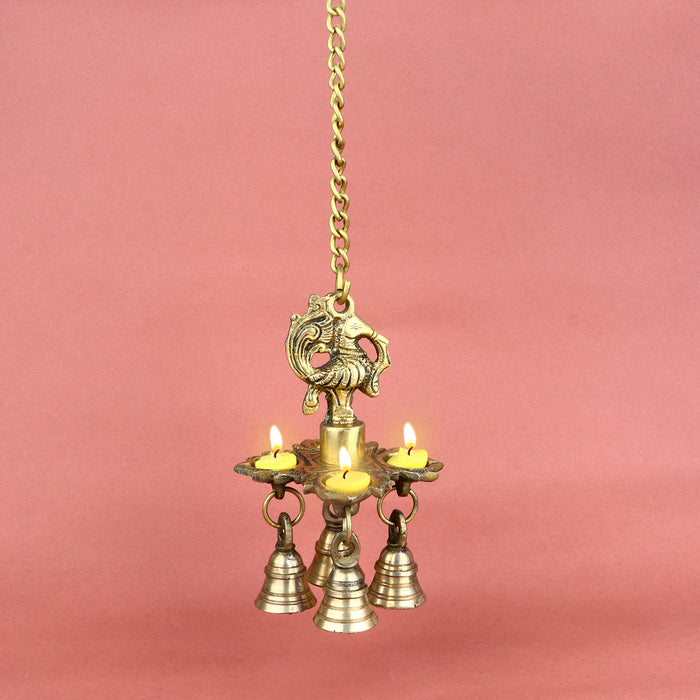 Intricately designed Brass Chaumukh Peacock Hanging Diya featuring four-faced oil lamps and detailed peacock motifs, adorned with hanging bells—perfect for temples, home mandirs, or festive decorations. India’s Largest Pooja Accessories Brand – www.satvikstore.in