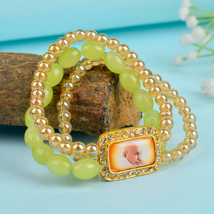Golden Clear & Green Triple Layer Guruji Swaroop Bracelet featuring sparkling golden clear beads with vibrant green middle layer and Jai Guruji Swaroop – perfect for spiritual wear, meditation, and gifting. India’s Largest Pooja Accessories Brand – www.satvikstore.in