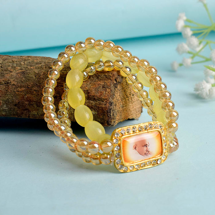 Golden Clear & Yellow Triple Layer Guruji Swaroop Bracelet featuring sparkling golden clear beads with bright yellow middle layer and Jai Guruji Swaroop – perfect for spiritual wear, meditation, and gifting. India’s Largest Pooja Accessories Brand – www.satvikstore.in