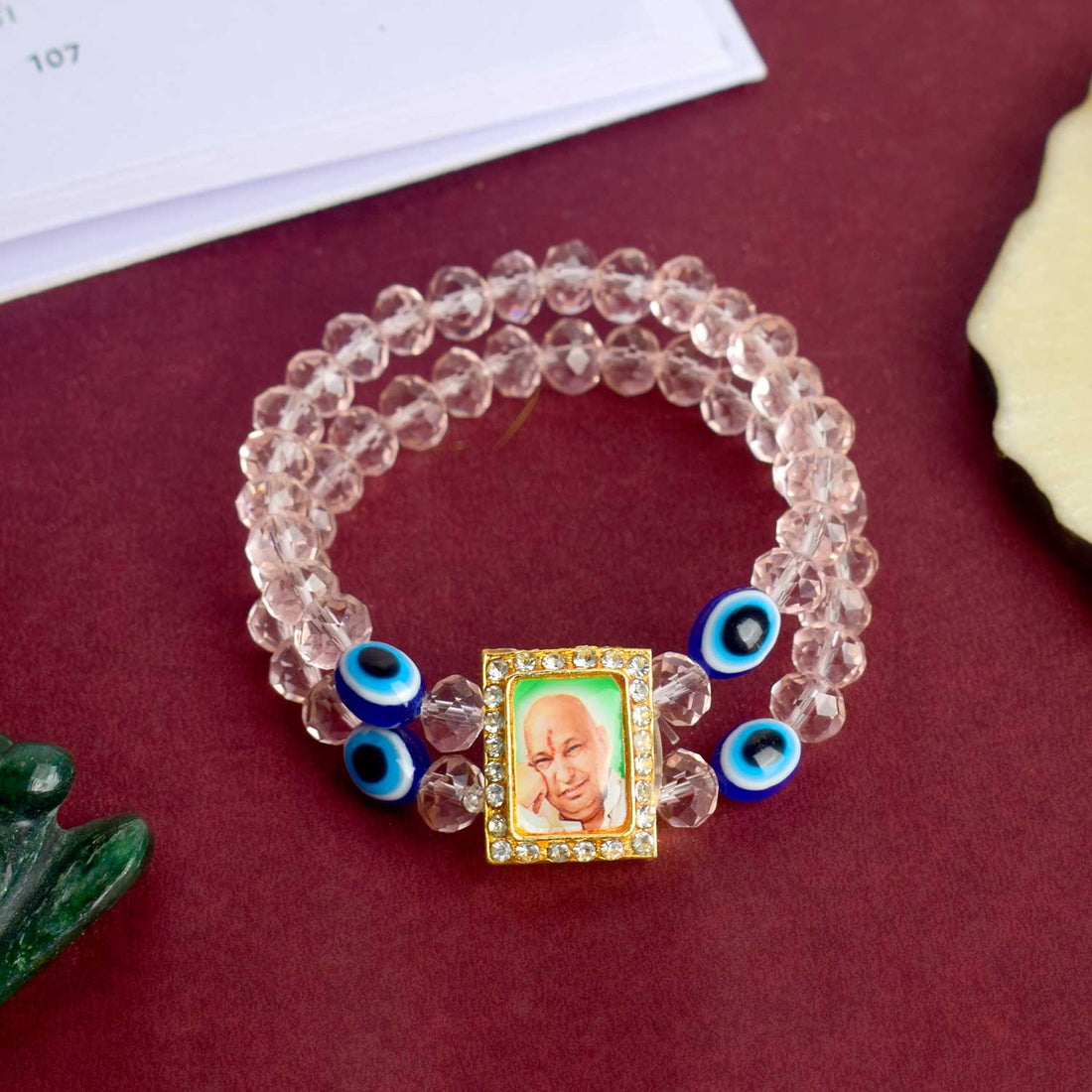 Jai Guruji Swaroop Bracelet with pink beads and Evil Eye charm, handcrafted for divine energy and spiritual protection. India’s Largest Pooja Accessories Brand – www.satvikstore.in