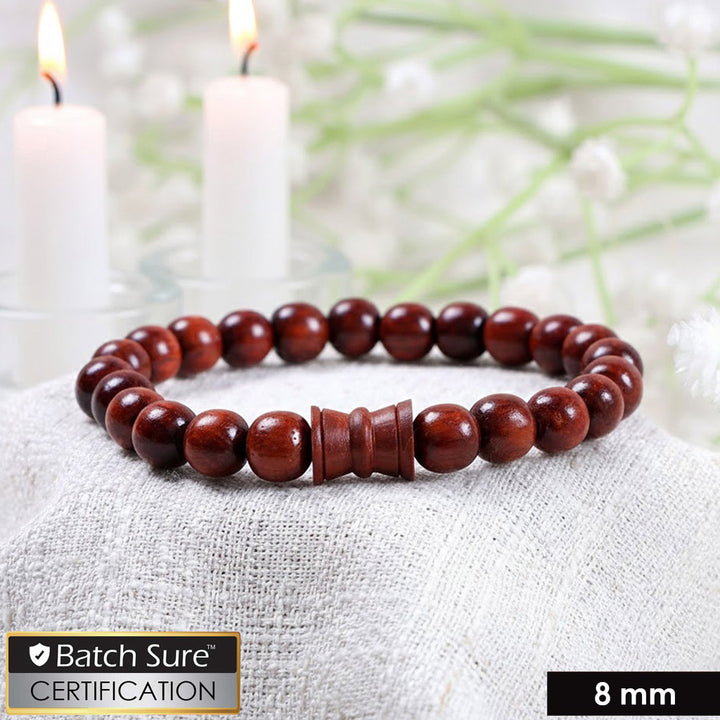 8mm red sandalwood bead bracelet with a central damru-shaped wooden bead on an elastic cord, shown against a neutral background. India’s Largest Puja Accessories Brand- www.satvikstore.in