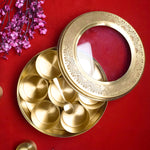 Premium Brass Pooja Samagridaan Set with 7 containers, spoon, and glass lid provides a luxurious and organized solution for storing your sacred puja items, ensuring an elegant and efficient ritual experience – India’s Largest Pooja Accessories Brand – www.satvikstore.in