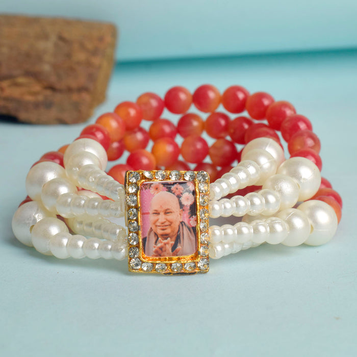Red & White Pearl Four Layer Guruji Swaroop Bracelet featuring vibrant red beads and luminous white pearls with Jai Guruji Swaroop – perfect for spiritual wear, festive gifting, and daily devotion. India’s Largest Pooja Accessories Brand – www.satvikstore.in