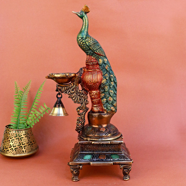 Satvik Stores Presents Brass Peacock Diya Stand.&nbsp;Any festive occasion will be made wonderfully auspicious by the grace and beauty of the Peacock Brass Handcrafted Hanging Diya. Given that it was made by hand, the piece's abnormalities and flaws only serve to enhance Diya's allure and charisma.