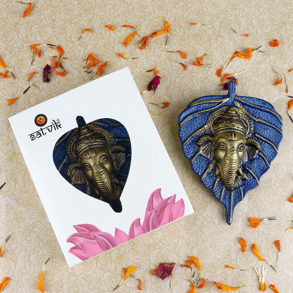 1 Pc Lord Ganesh Face on Leaf Patta Wall Hanging – Intricately designed wall decor featuring Lord Ganesha’s face embossed on a green leaf-shaped patta for spiritual ambiance. India’s Largest Pooja Accessories Brand – www.satvikstore.in